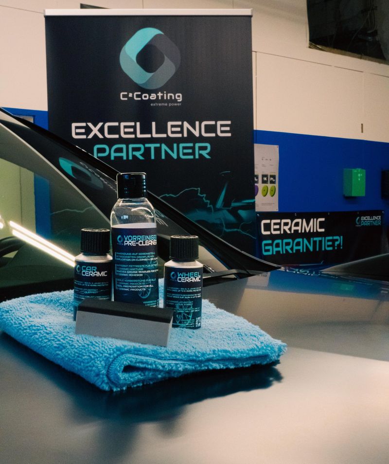 C²Coating Excellence-Partner-Aufsteller mit Car-Ceramic-Produkten auf einem Mikrofasertuch